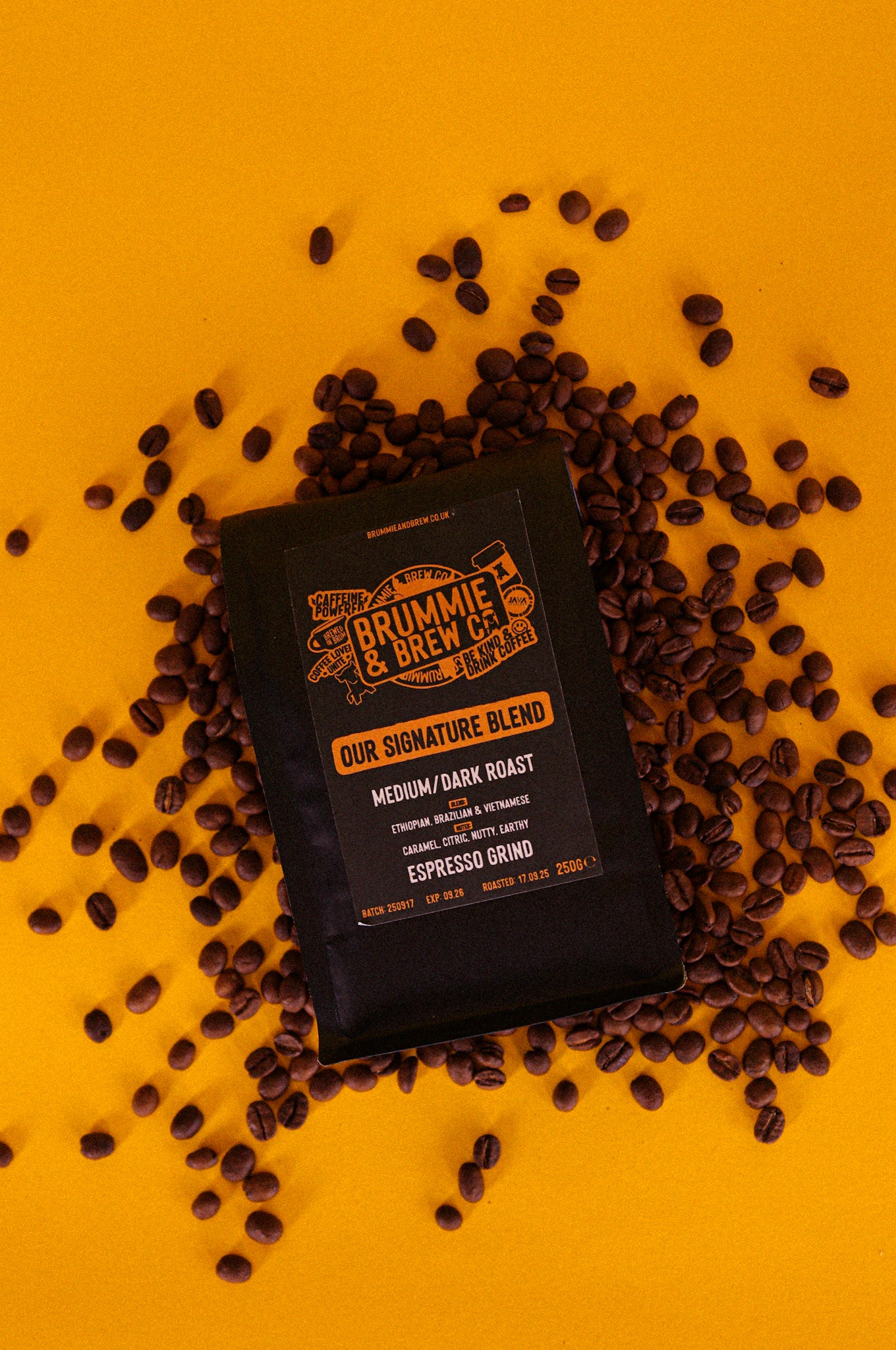 Brummie & Brew coffee packaging surrounded by speciality coffee beans on a yellow background